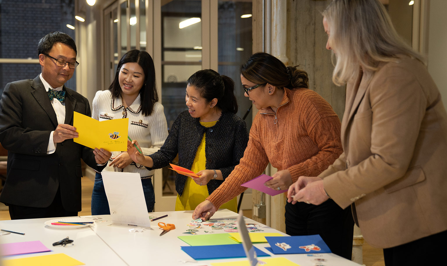 People assembling paper crafts